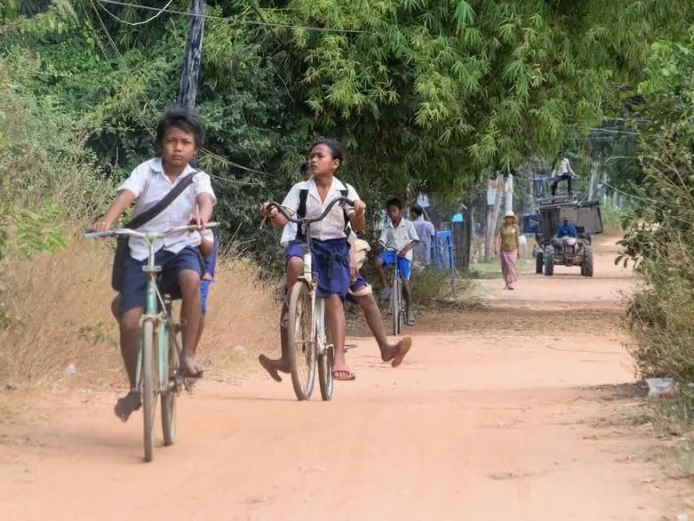 Cambodian children cycling from school