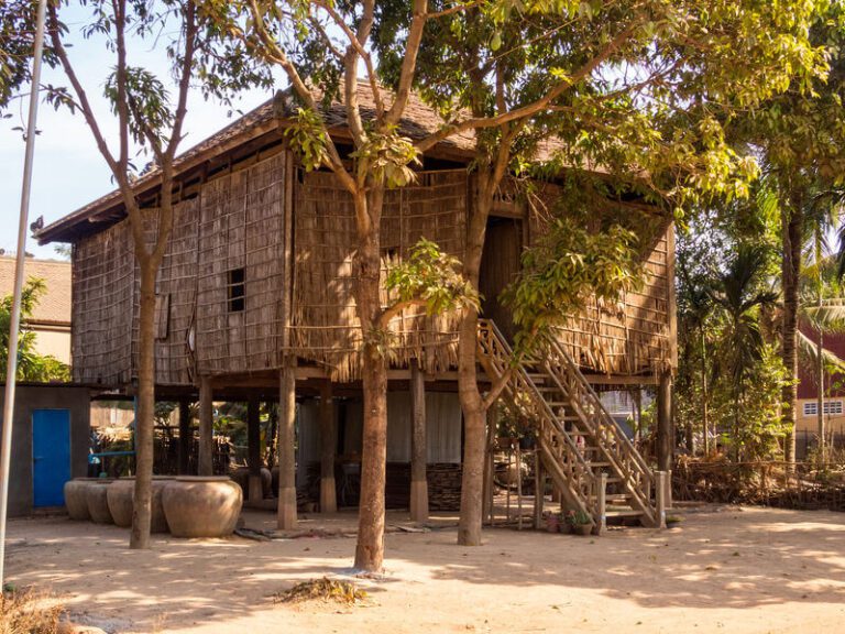 Why Are Cambodian Houses Built On Stilts? A Bus On a Dusty Road