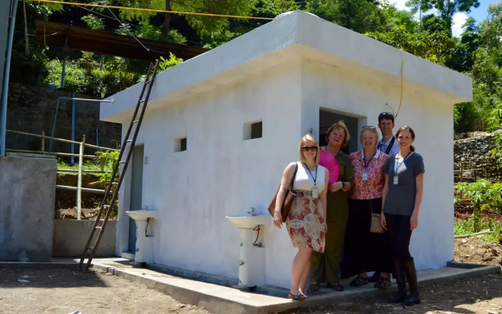 Anita Hummel with team of Project Sprouts outside a toilet they raised funds for an impoverished Elementary School in Lao Cao Vietnam.