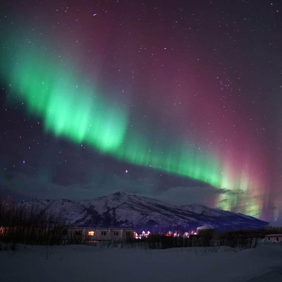 Guide To Where To See Northern Lights In The USA A Bus On a Dusty Road