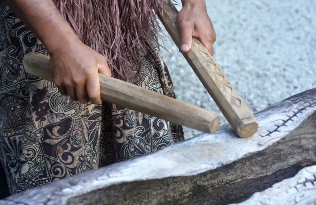 A polynesian guy doing a drumming with their handmade drums