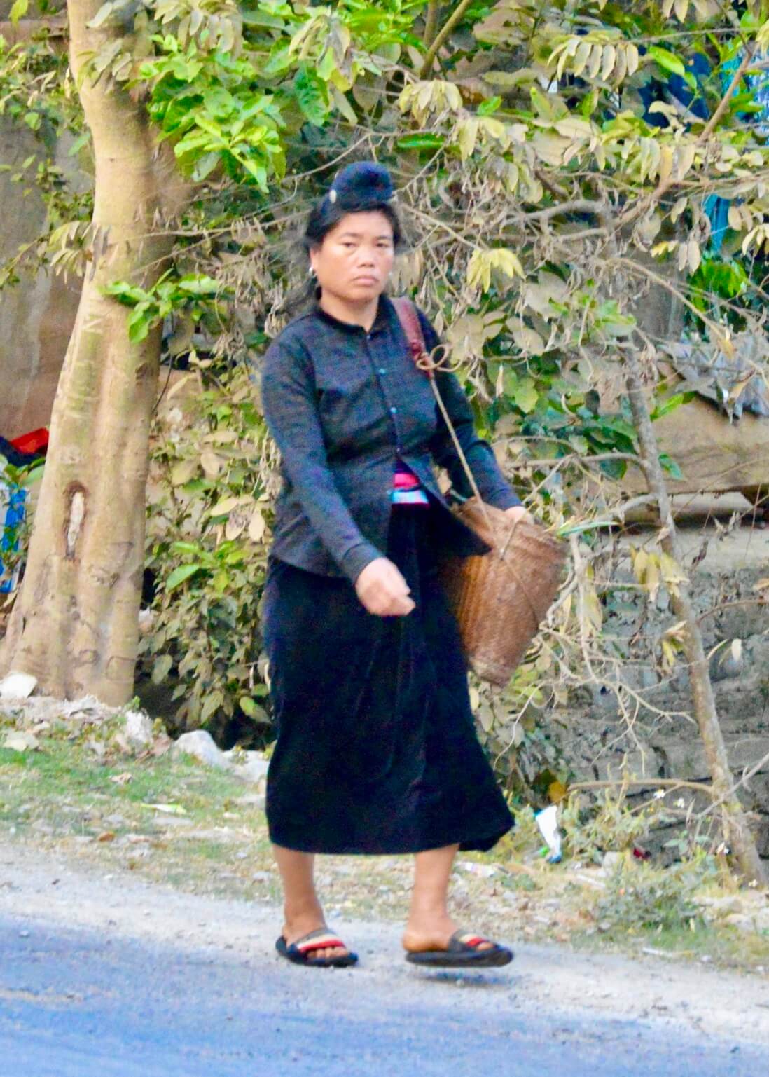  a Thai Woman walking down the street in Vietnam 