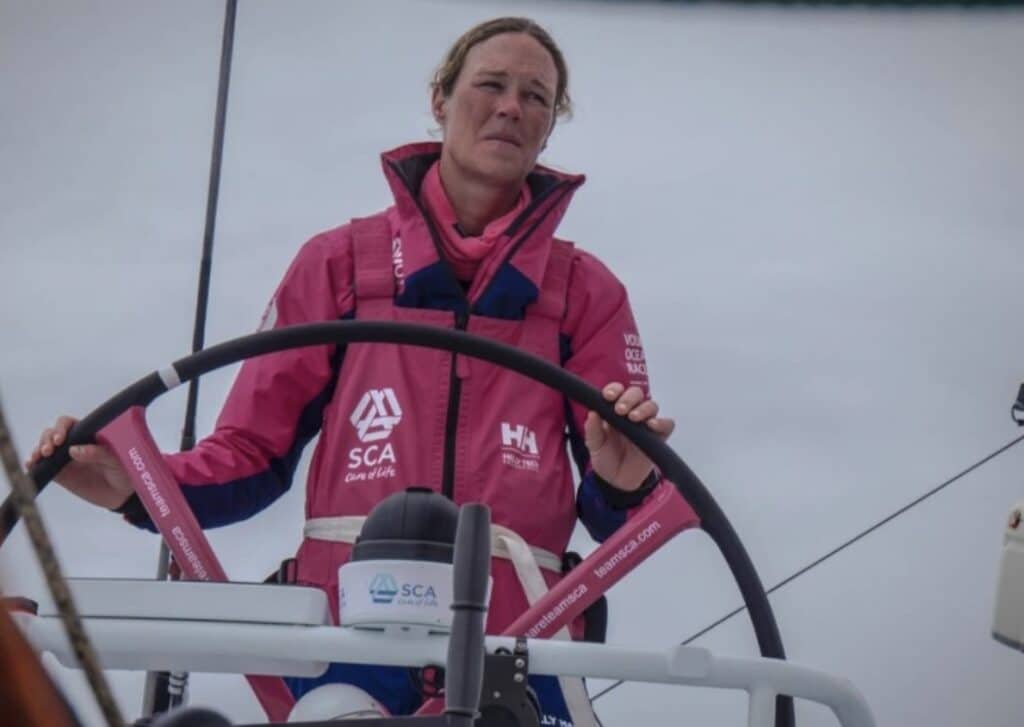 a woman in a pink jacket on a boat