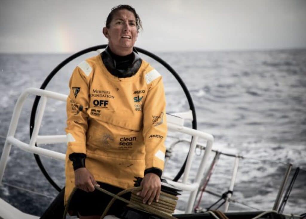 a woman in a yellow jacket on a boat