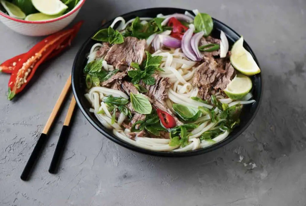 a bowl of soup with meat and vegetables