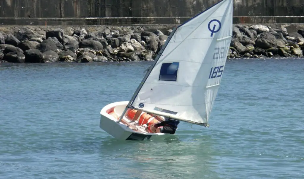 a person in a sailboat in the water